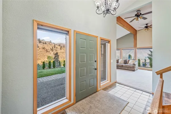 a view of hallway with livingroom and stairs