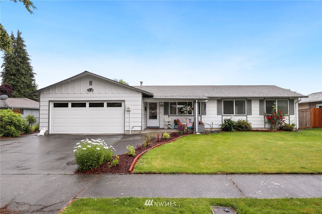 16 R Place Northeast Auburn, WA 98002 - Photo 1 of 12 a front view of a house with garden and patio