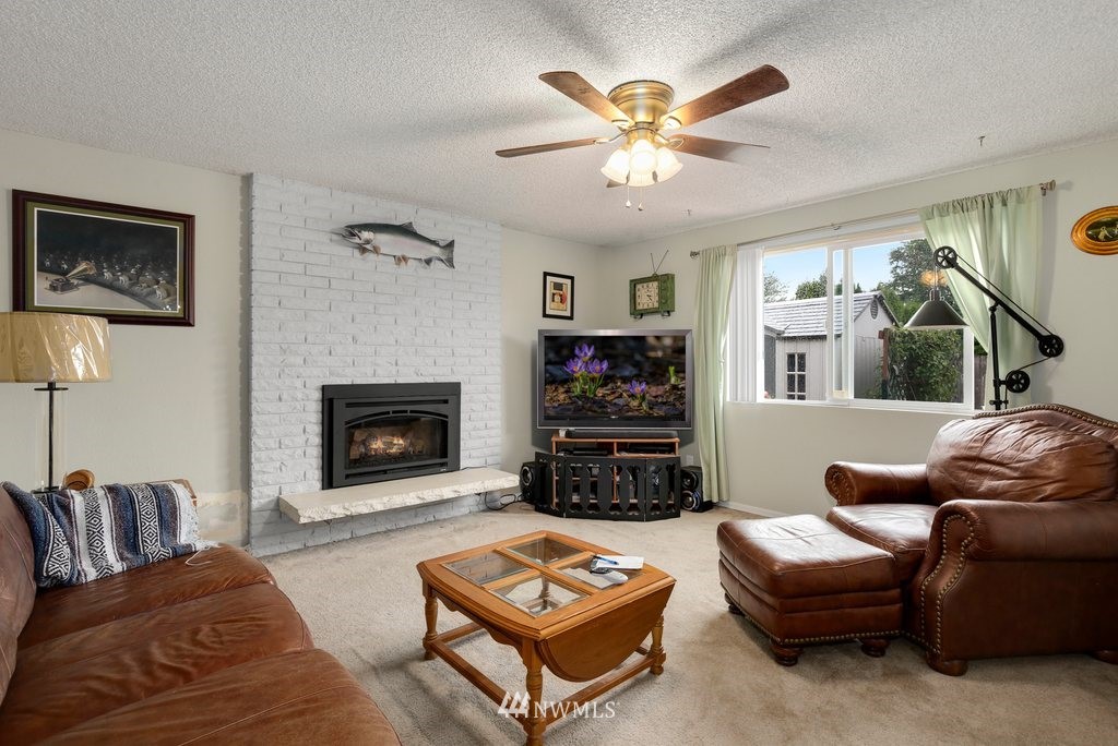 16 R Place Northeast Auburn, WA 98002 - Photo 3 of 12 a living room with furniture a fireplace and a flat screen tv