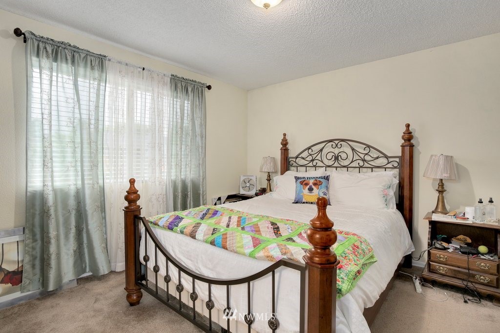 16 R Place Northeast Auburn, WA 98002 - Photo 6 of 12 a bedroom with furniture and a chandelier