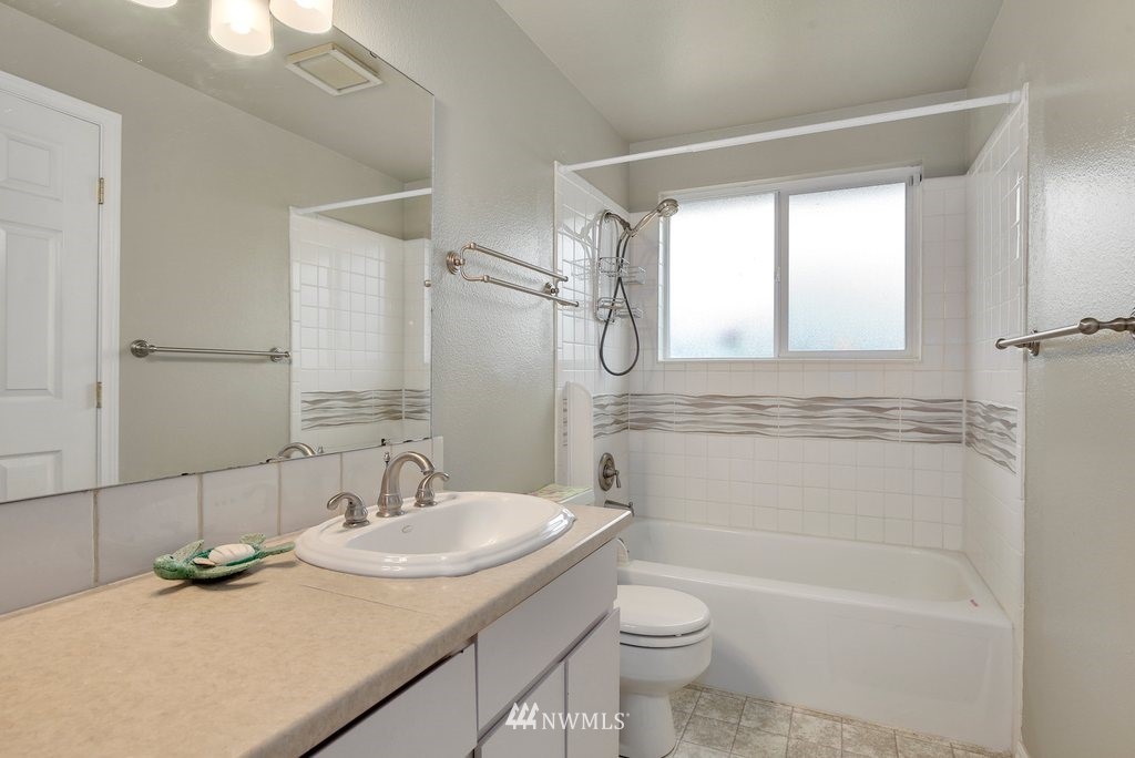 16 R Place Northeast Auburn, WA 98002 - Photo 8 of 12 a bathroom with a granite countertop sink toilet and shower