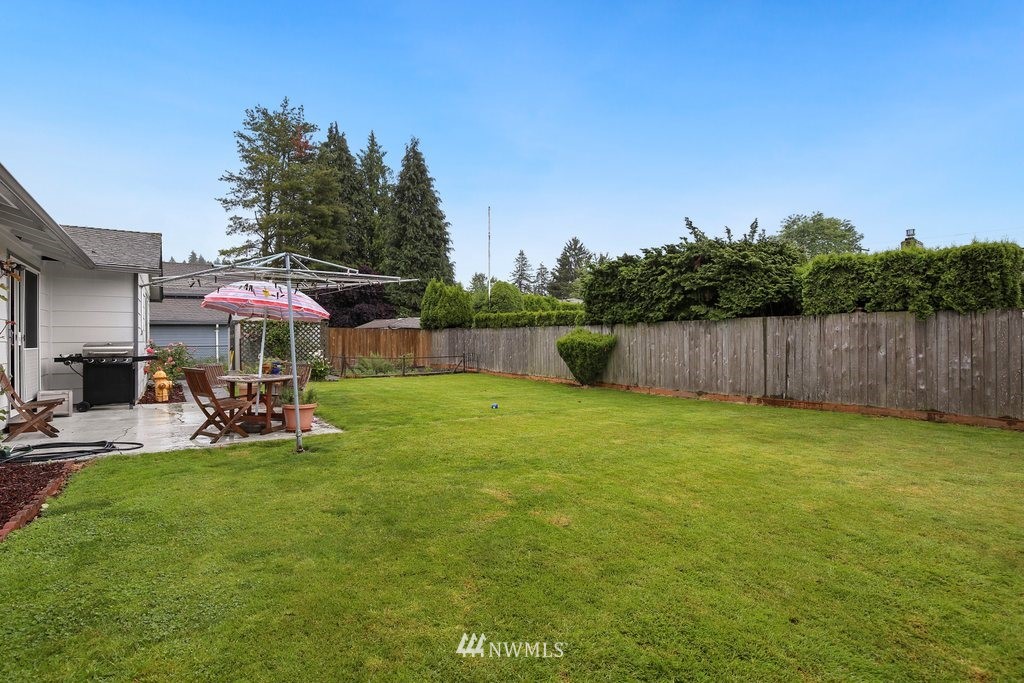 16 R Place Northeast Auburn, WA 98002 - Photo 10 of 12 a view of a backyard with a sitting area and slide
