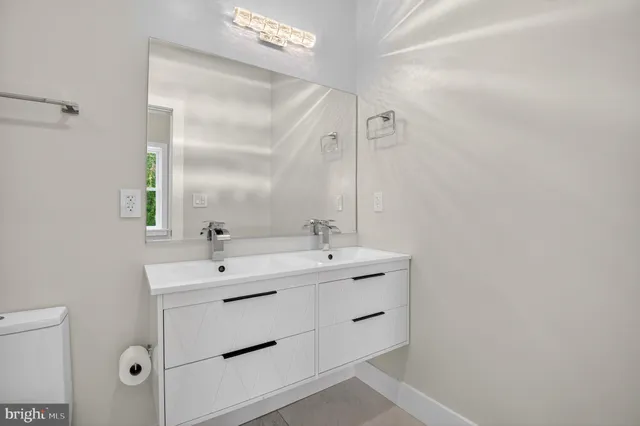 a bathroom with a double vanity sink and mirror