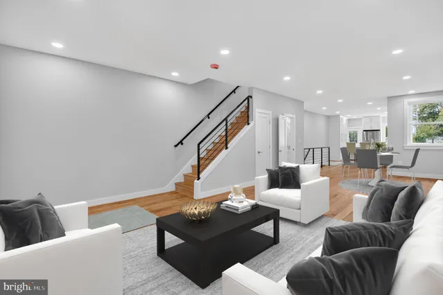 a living room with furniture and stairs