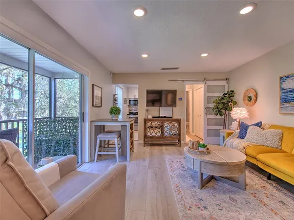 a living room with furniture a rug and a painting on the wall