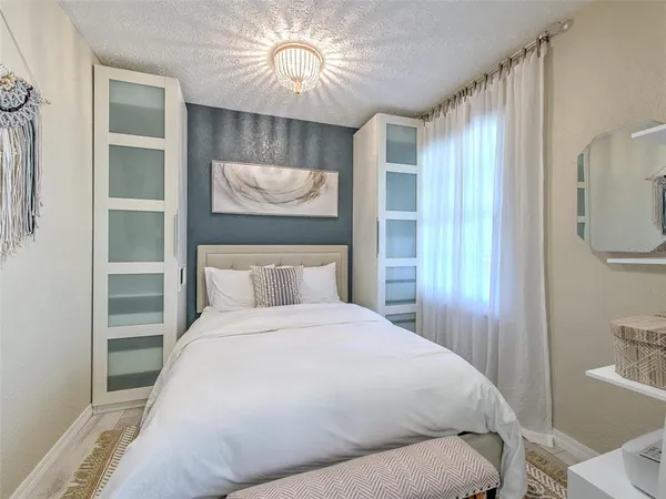 a bedroom with a bed and a chandelier