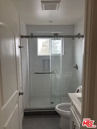 a bathroom with a shower and a toilet