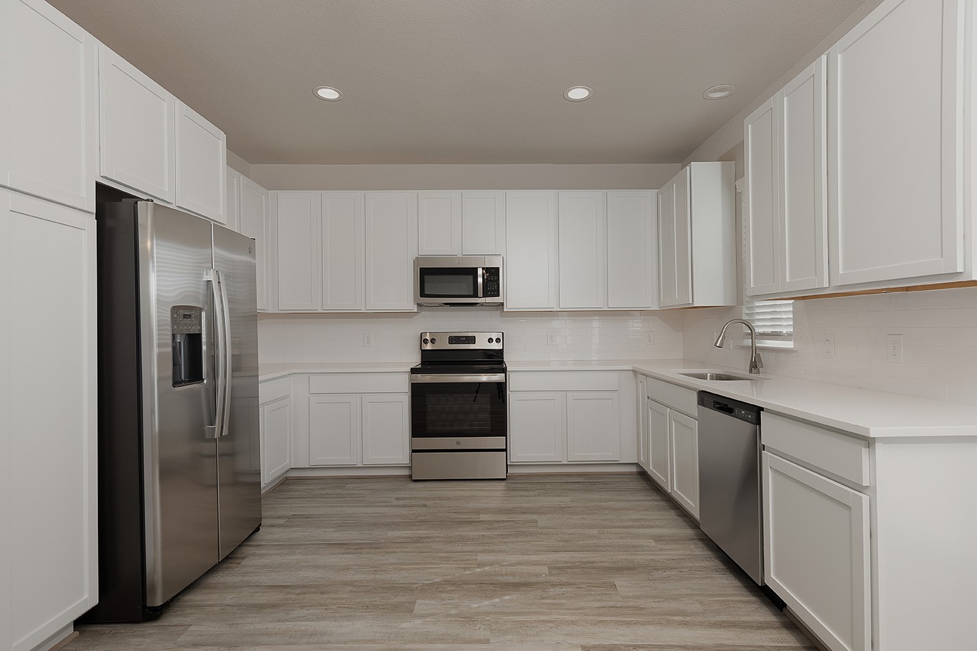 15770 Old Conroe Road, Unit 15003 Conroe, TX 77384 - Photo 5 of 16 Functional kitchen with stainless steel appliances and quartz countertops.