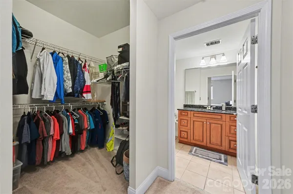 a view of walk in closet with clothes