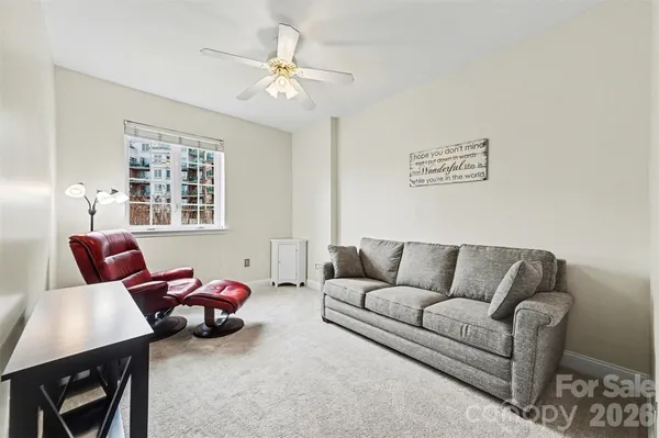 a living room with furniture a table and a window