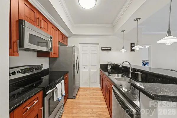a kitchen with stainless steel appliances granite countertop a stove and a sink