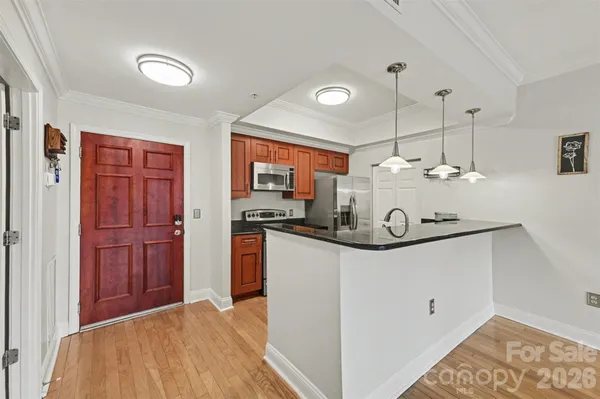 a kitchen with stainless steel appliances granite countertop a sink and refrigerator