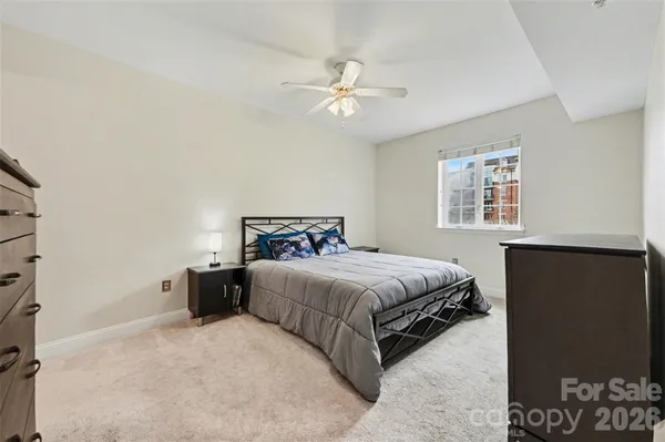 a bedroom with a bed and a night stand