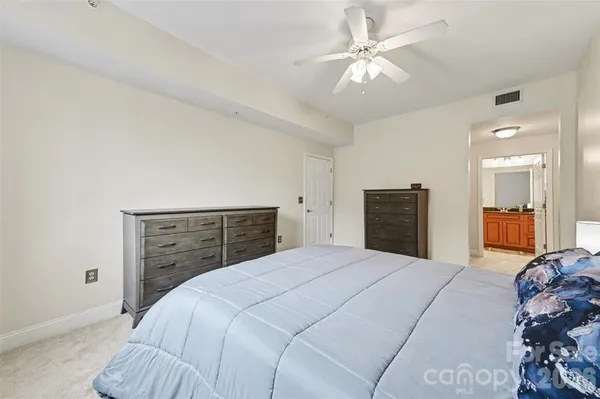 a bedroom with a large bed and a dresser