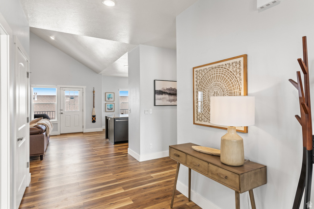 1343 North Trapper Loop Garden City, UT 84028 - Photo 2 of 56 Hall with vaulted ceiling and dark wood-style flooring
