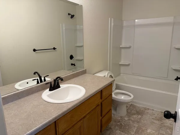 a bathroom with a sink toilet a mirror and shower