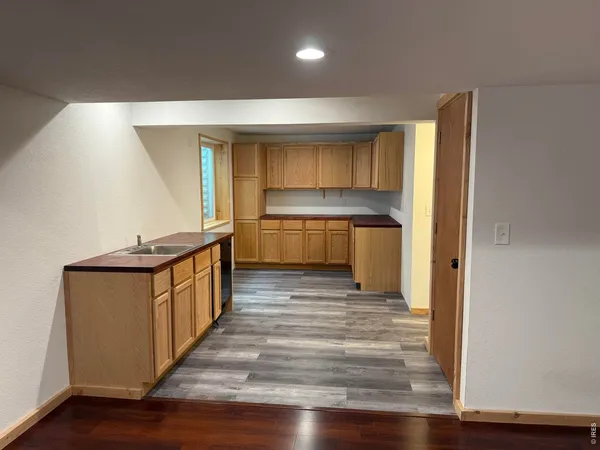a kitchen with sink and cabinets