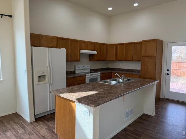 a kitchen with a stove and a refrigerator