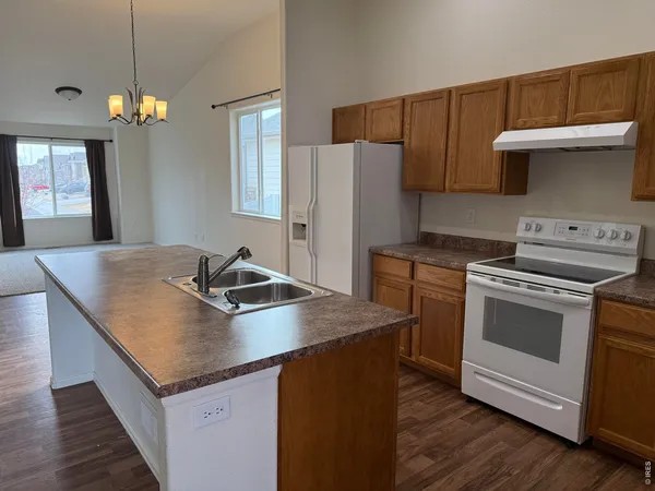 a kitchen with granite countertop a stove and a sink