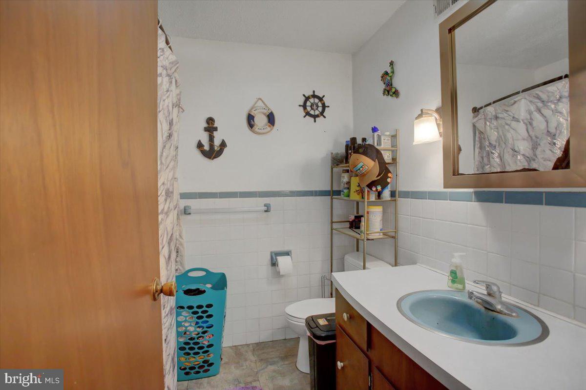 8582 Rice Road Shippensburg, PA 17257 - Photo 31 of 41 a bathroom with a sink a toilet and mirror