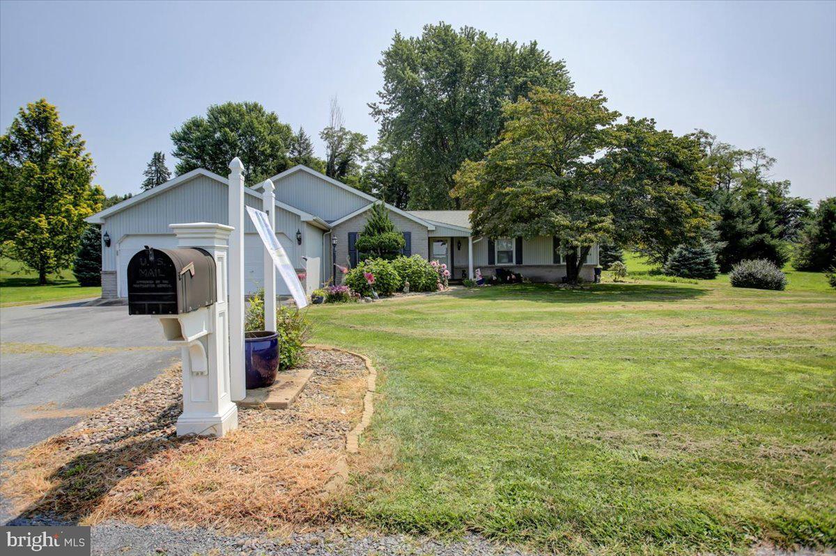 8582 Rice Road Shippensburg, PA 17257 - Photo 35 of 41 a view of a white house with a yard and garage