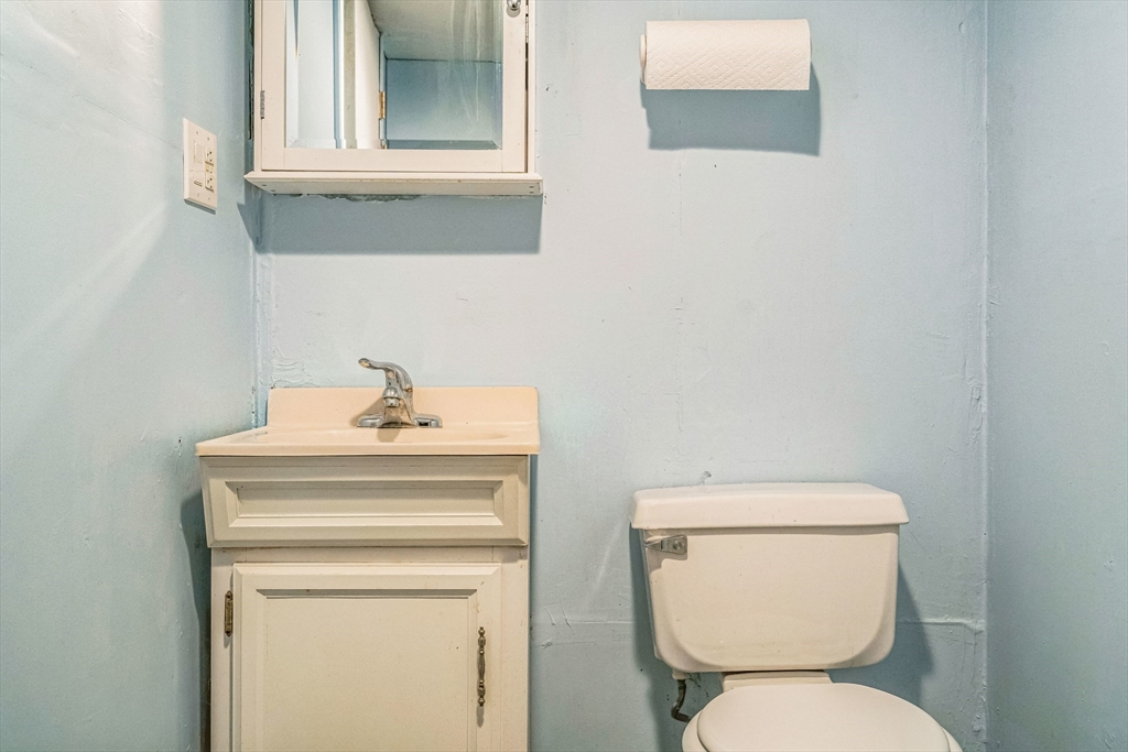 171 Virginia Road Waltham, MA 02453 - Photo 23 of 25 a bathroom with a toilet sink and mirror