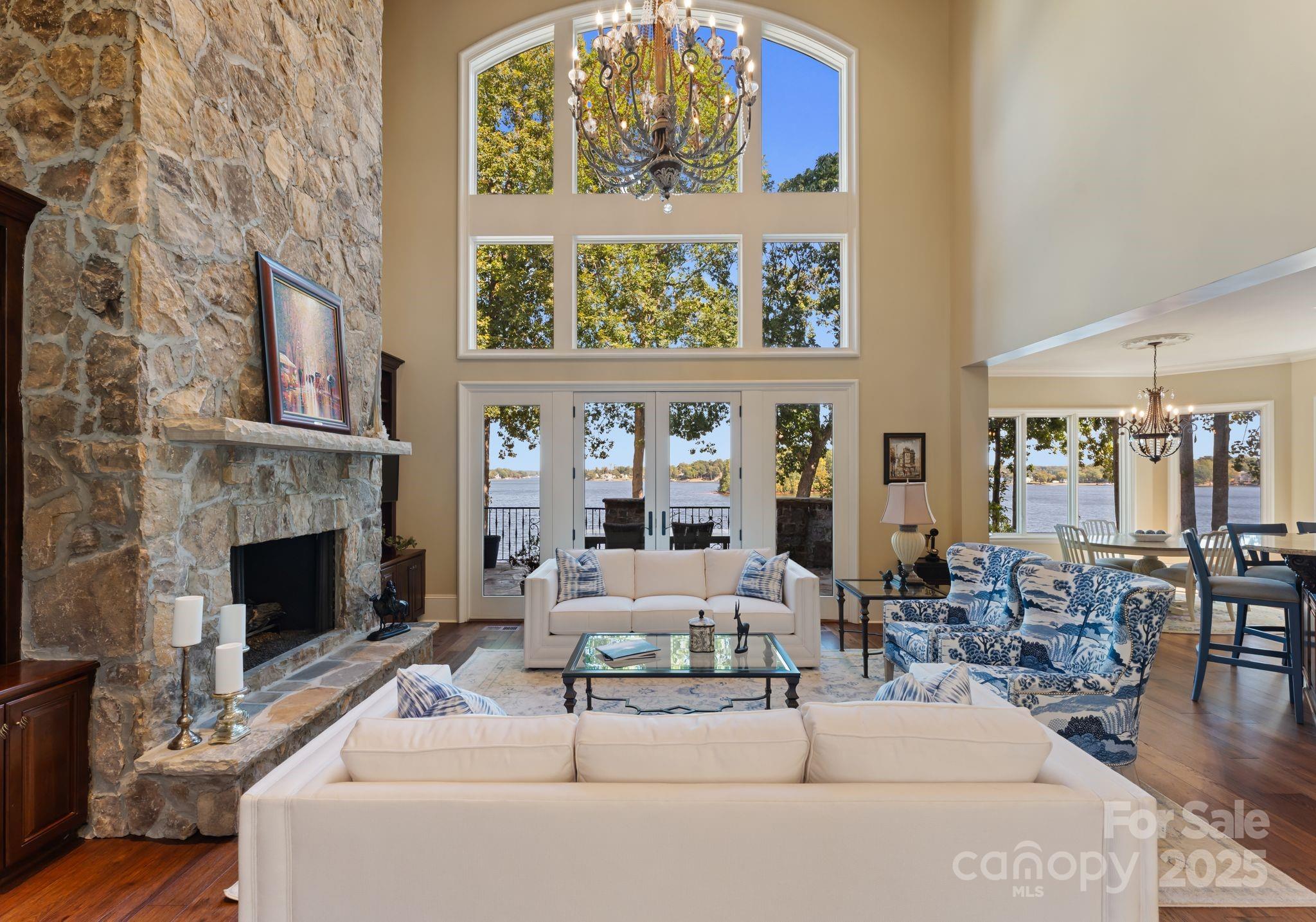 115 Emerald Point Lane Mooresville, NC 28117 - Photo 7 of 38 a living room with furniture a fireplace and a large window