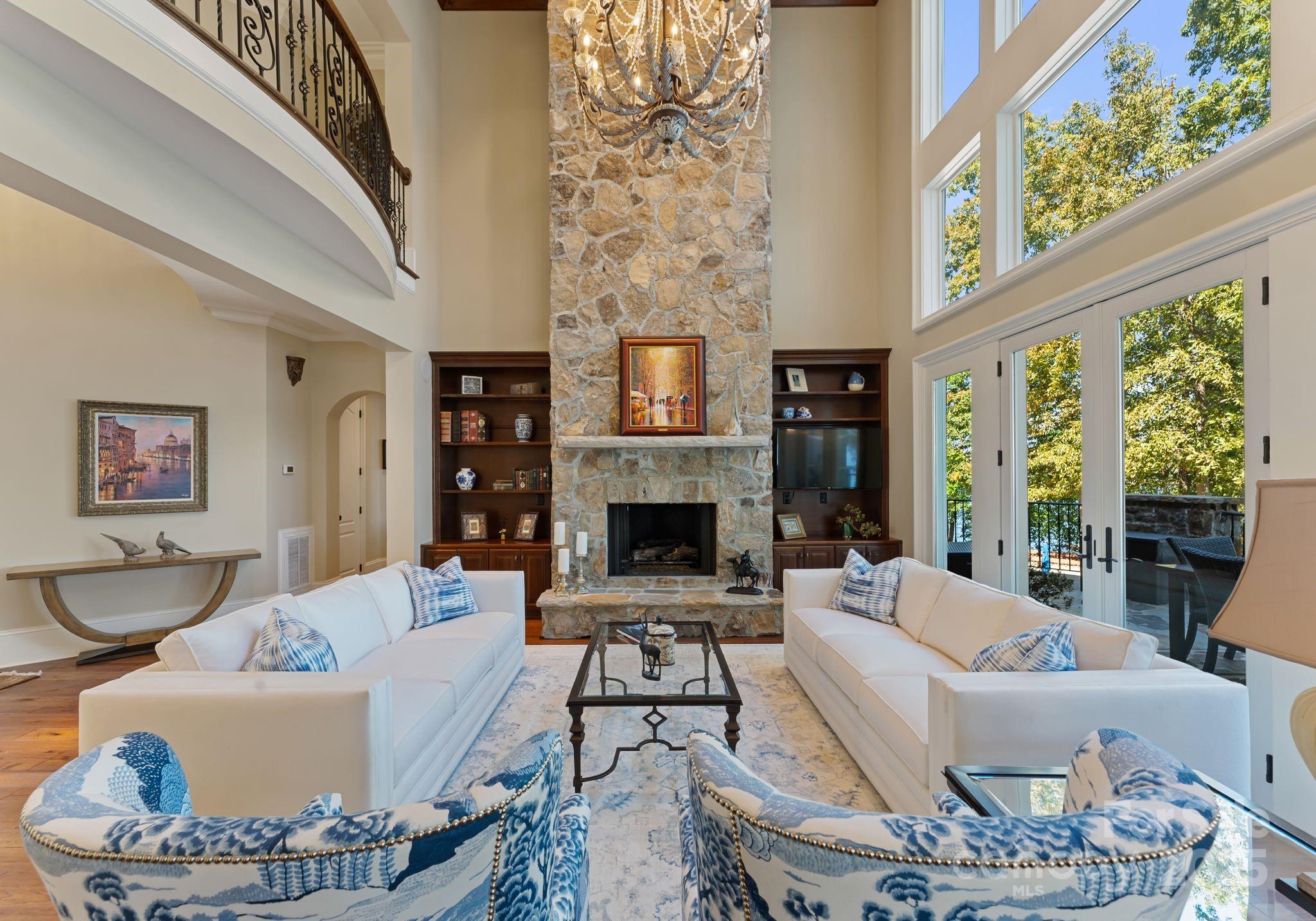 115 Emerald Point Lane Mooresville, NC 28117 - Photo 8 of 38 a living room with furniture a fireplace and a large window