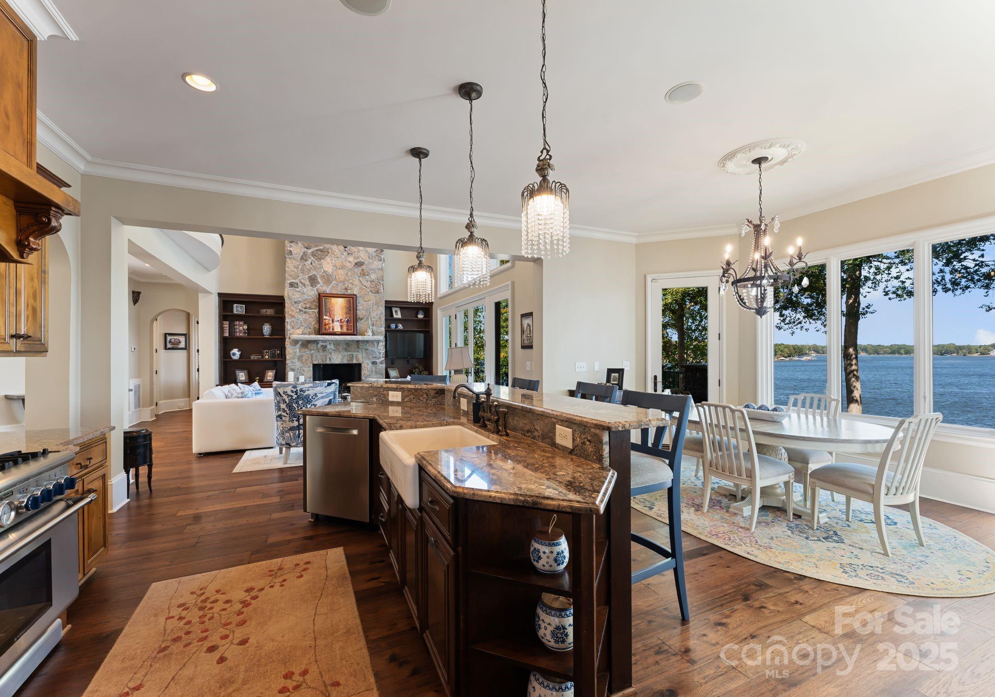 115 Emerald Point Lane Mooresville, NC 28117 - Photo 9 of 38 a view of a dining room and livingroom with furniture wooden floor a chandelier