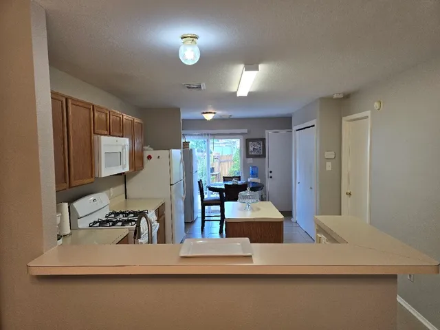 a dining room with furniture and a chandelier