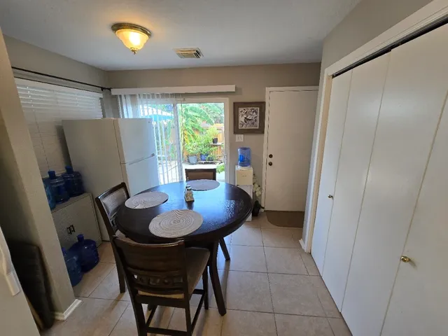 a bedroom with a bed and a chair with the potted plant