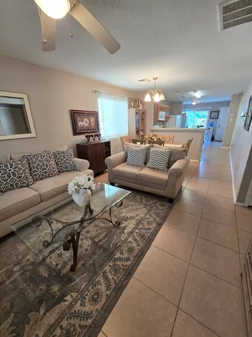 a living room with furniture and flat screen tv