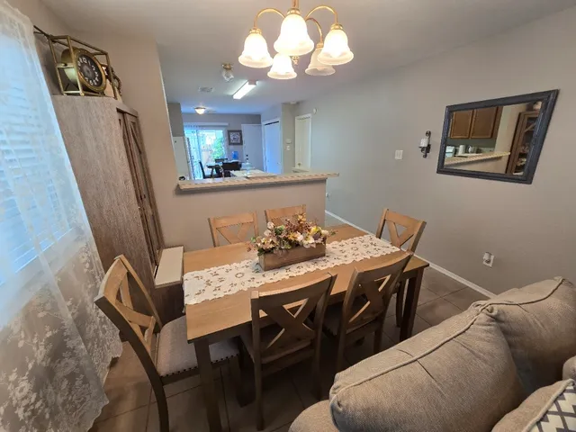 a living room with furniture a dining table and a window