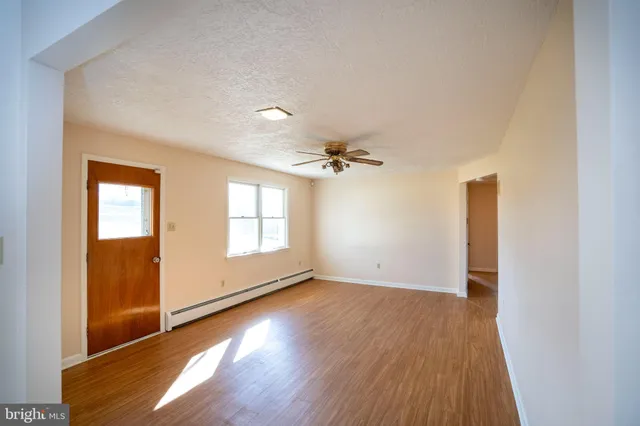 wooden floor in an empty room with a window