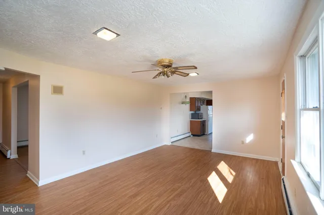 a view of a room with wooden floor and a window
