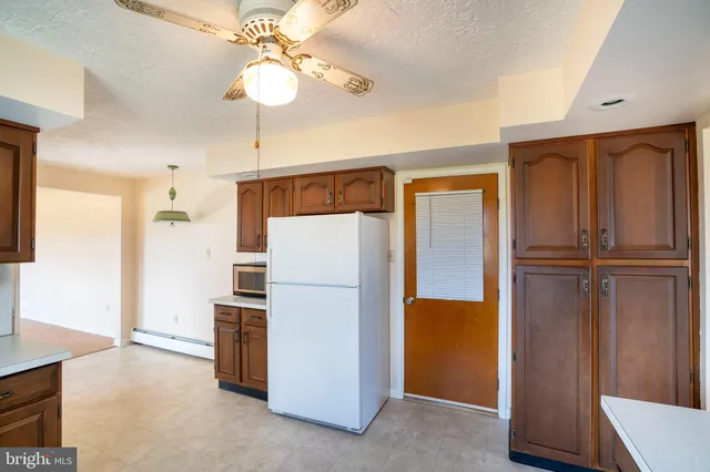 a kitchen with refrigerator and window