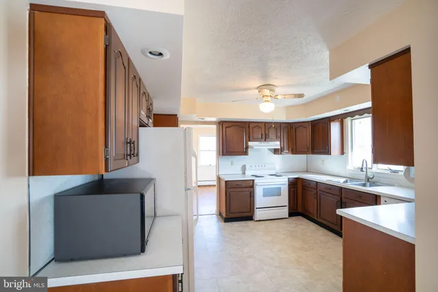 a large kitchen with a cabinets and stainless steel appliances