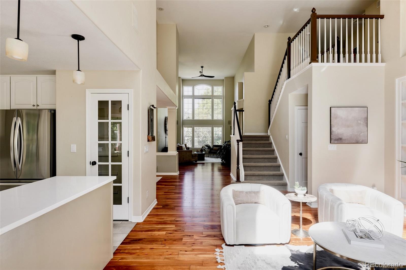 1347 Pine View Road Golden, CO 80403 - Photo 16 of 50 a living room with furniture a fireplace and a chandelier