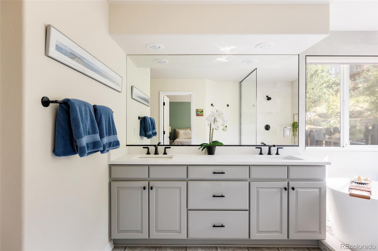 1347 Pine View Road Golden, CO 80403 - Photo 20 of 50 a bathroom with a double vanity sink and mirror