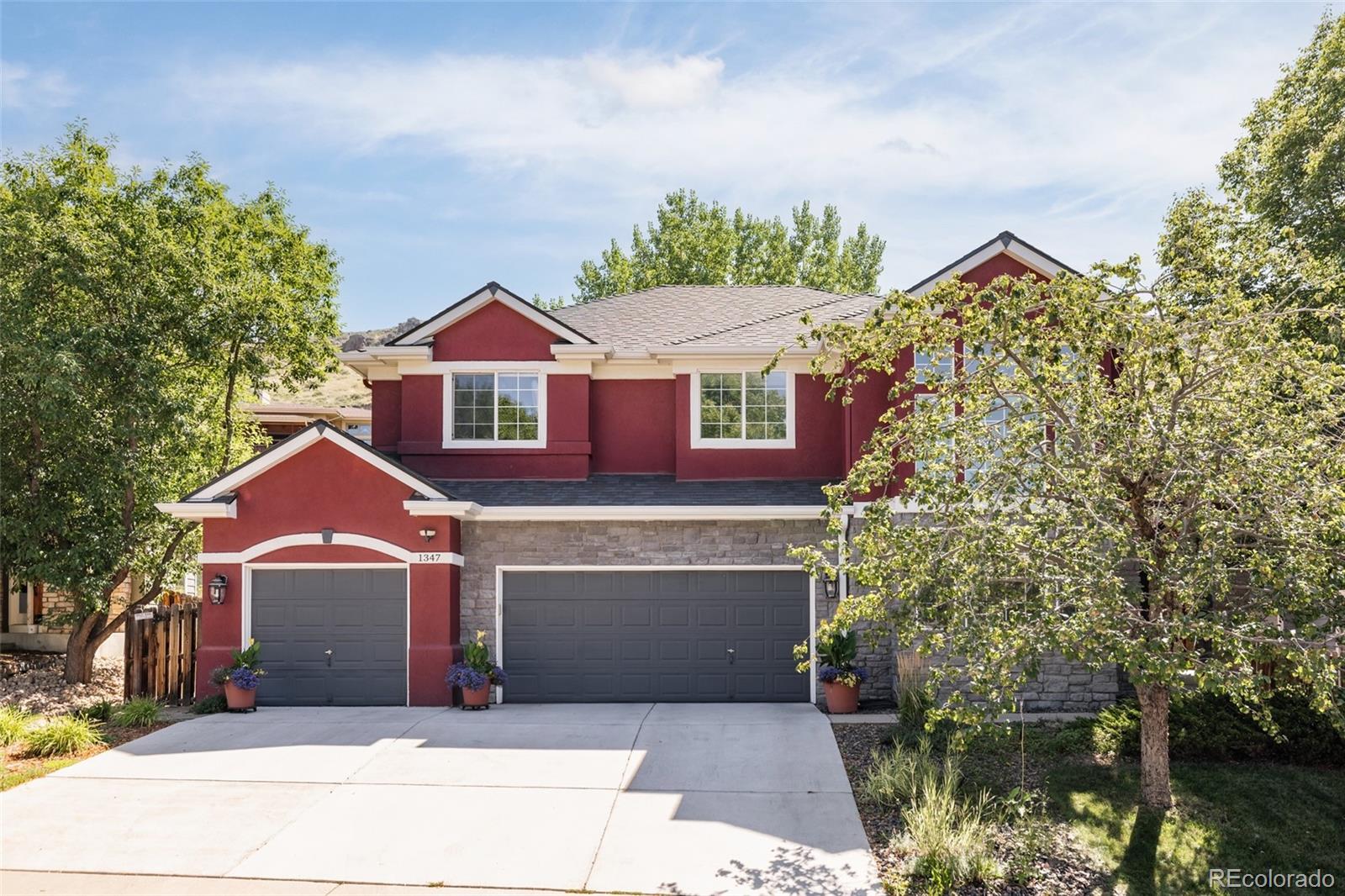 1347 Pine View Road Golden, CO 80403 - Photo 2 of 50 a front view of a house with a yard and garage