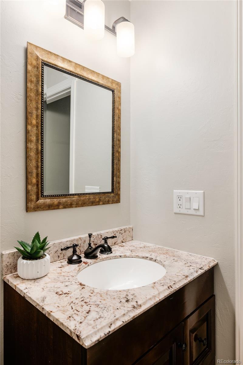 1347 Pine View Road Golden, CO 80403 - Photo 26 of 50 a bathroom with a granite countertop sink and a mirror