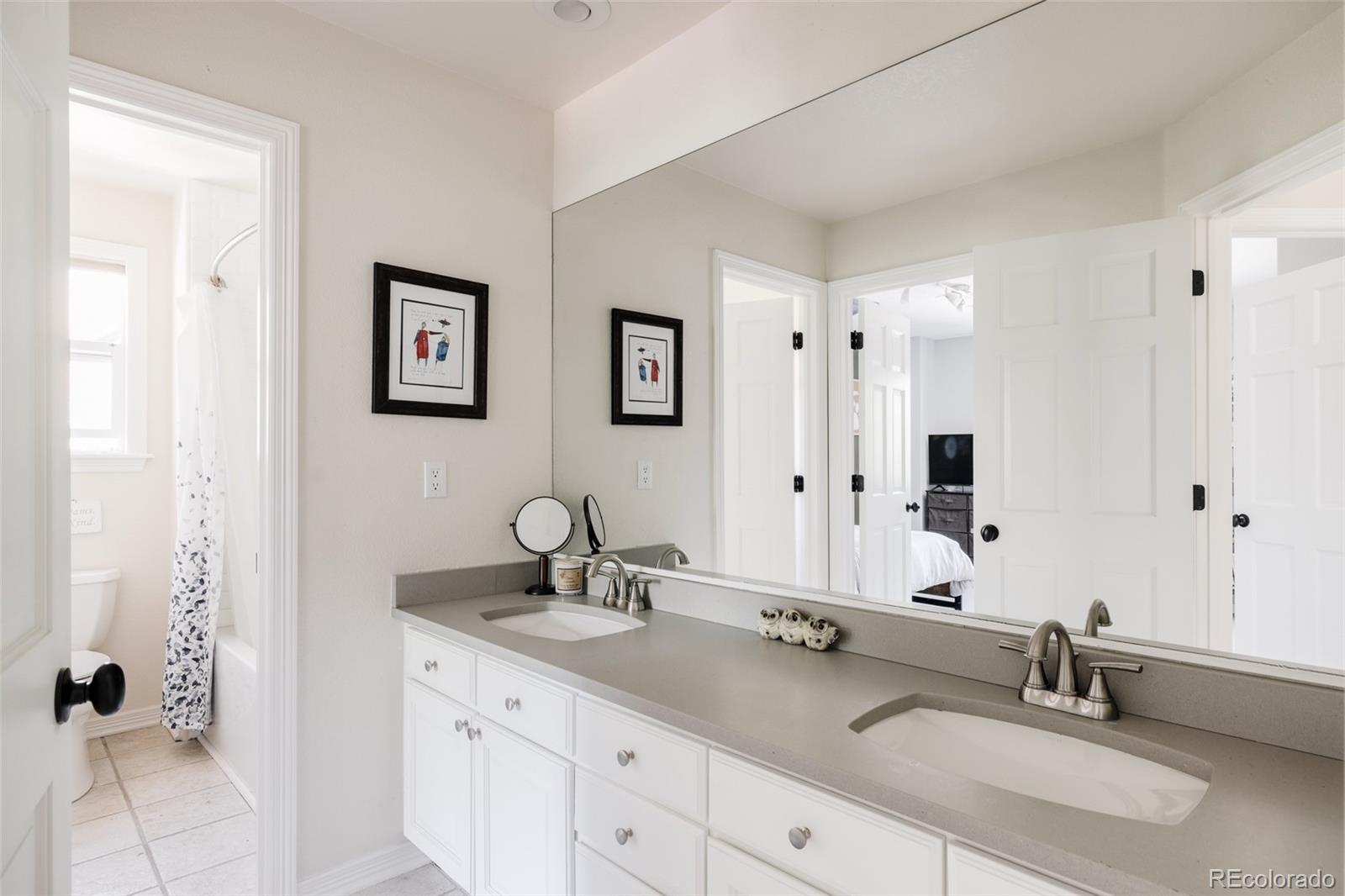 1347 Pine View Road Golden, CO 80403 - Photo 31 of 50 a bathroom with double sink and a mirror
