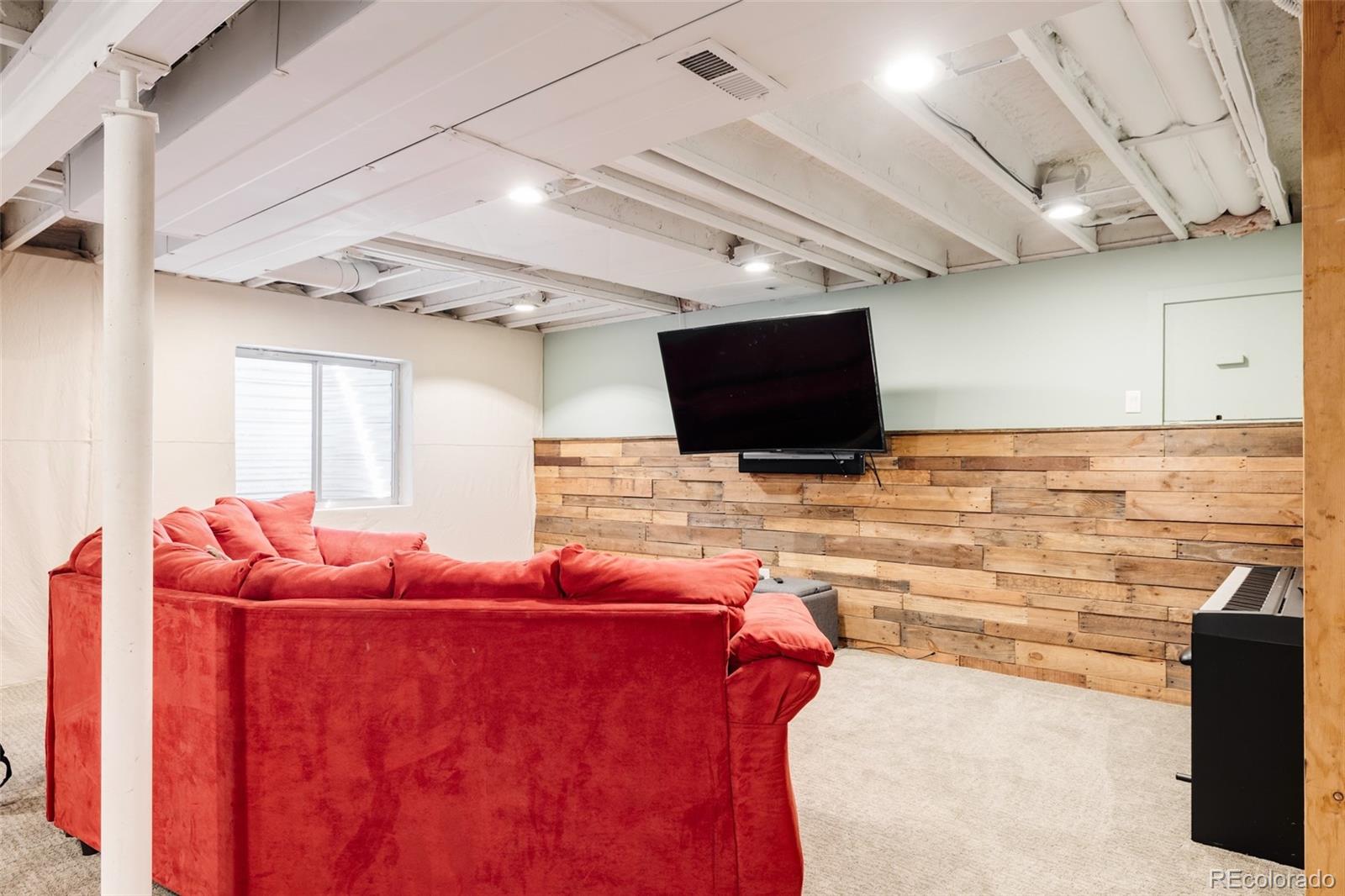 1347 Pine View Road Golden, CO 80403 - Photo 33 of 50 a living room with furniture and a flat screen tv