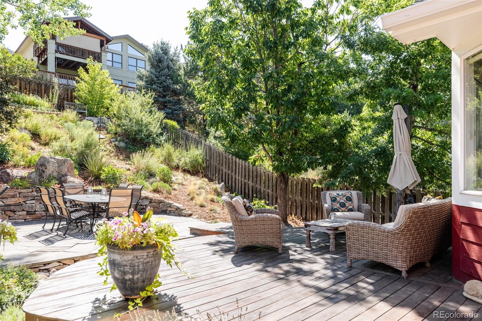 1347 Pine View Road Golden, CO 80403 - Photo 37 of 50 a view of a patio with couches chairs and a potted plant
