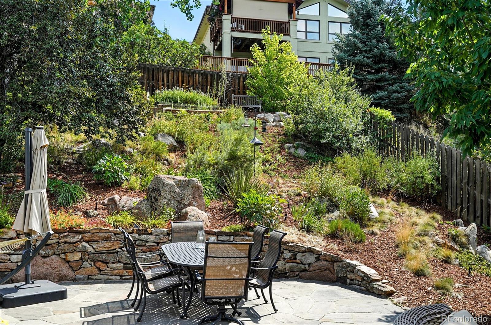 1347 Pine View Road Golden, CO 80403 - Photo 38 of 50 a view of a chair and table in backyard