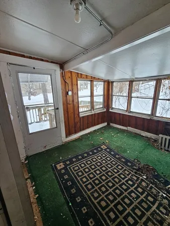 a view of a livingroom with a ceiling fan and window