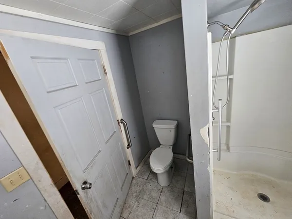 a bathroom with a sink a toilet a window and tub