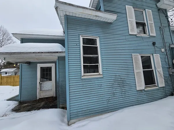 a brick house with a yard and garage