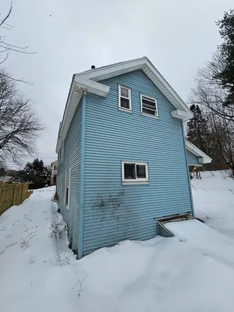 a view of house with snow on roof