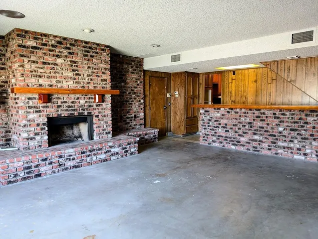 a view of an empty room with a fireplace
